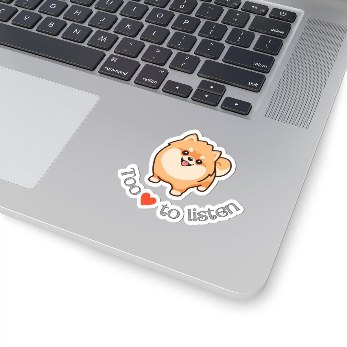 Kiss-cut sticker with Pomeranian graphic and too cute to listen slogan applied to laptop surface