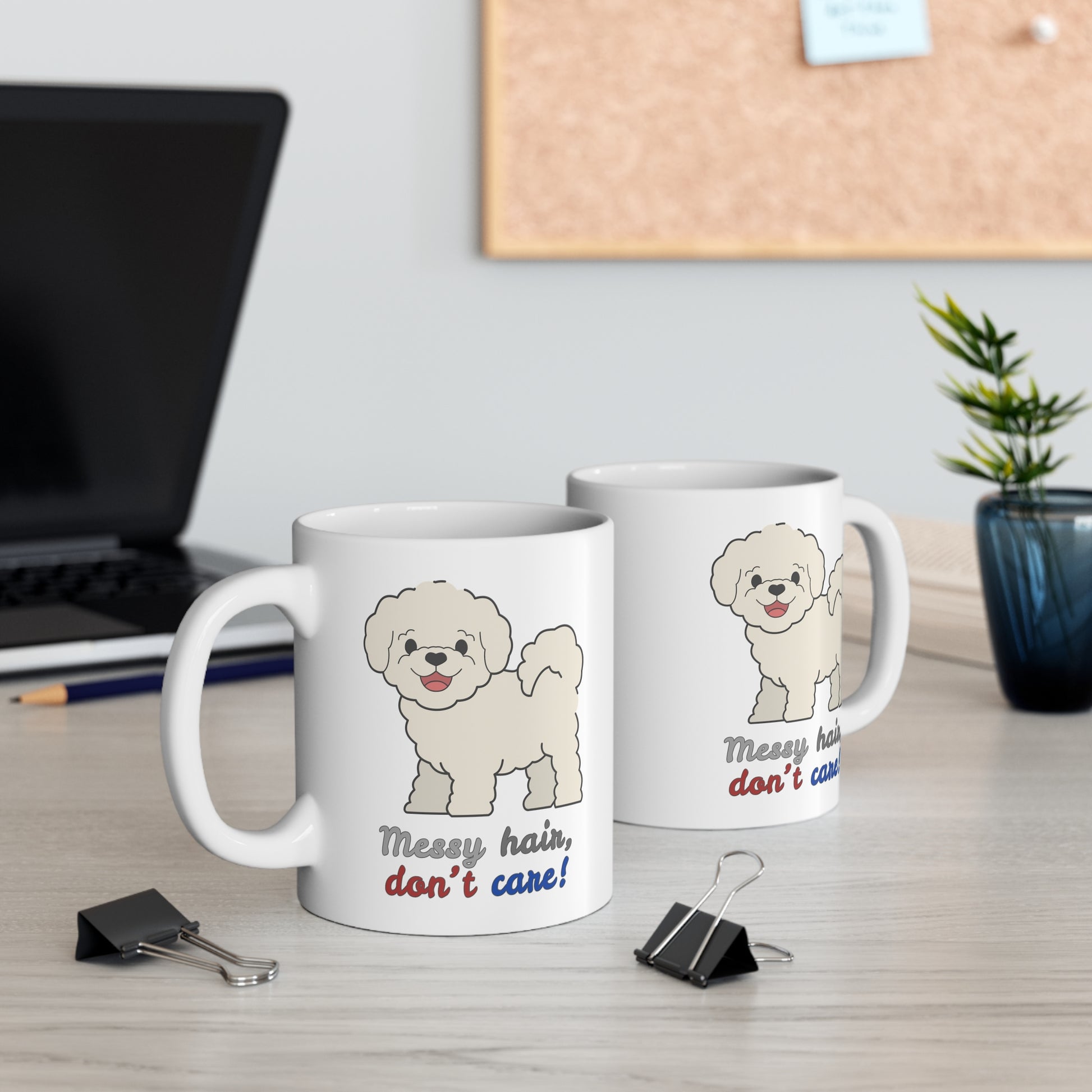 Two white coffee mugs with bichon dog graphic and messy hair don’t care slogan on table one shown from left side one from right side