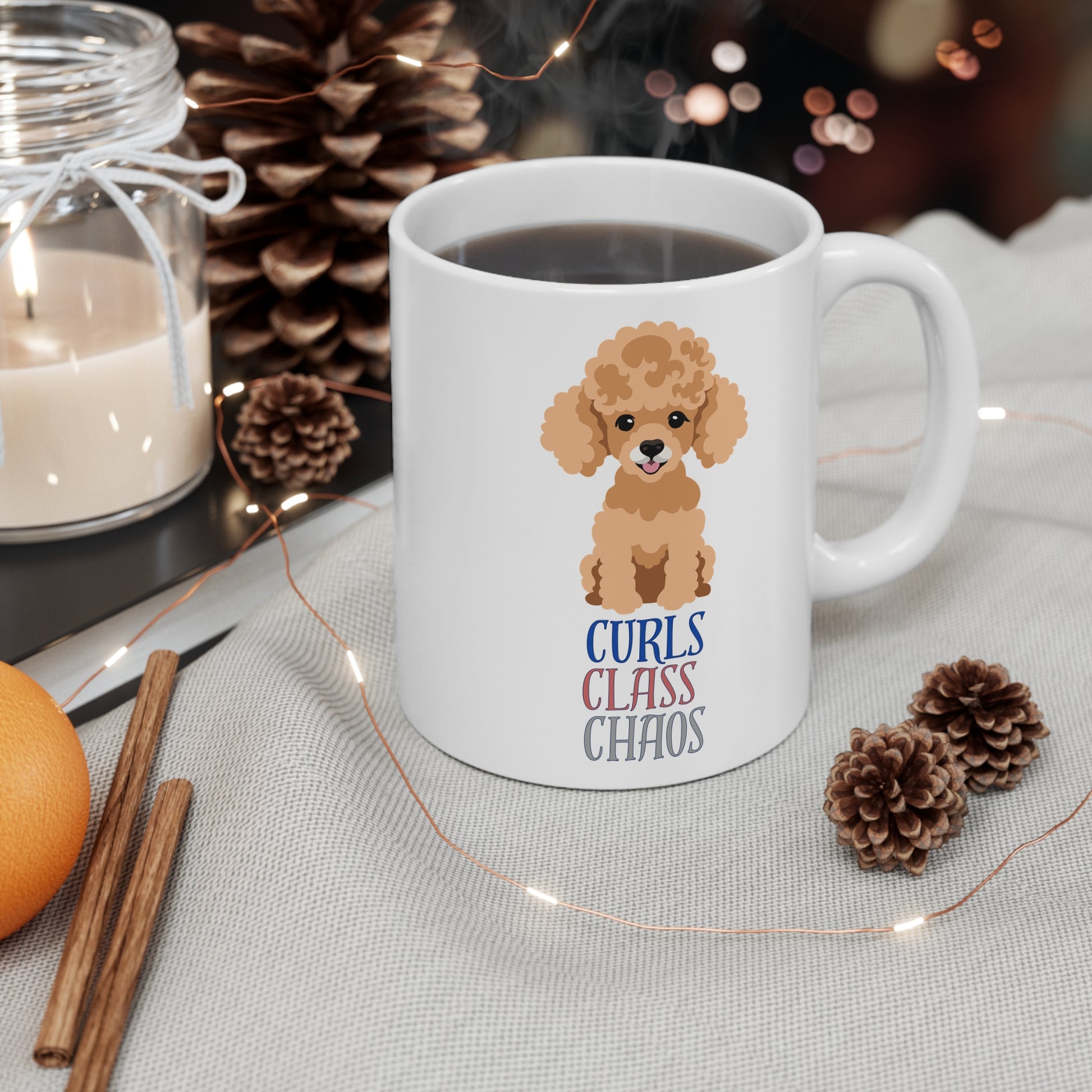 White coffee mug with poodle graphic and curls class chaos slogan placed on table with Christmas decorations
