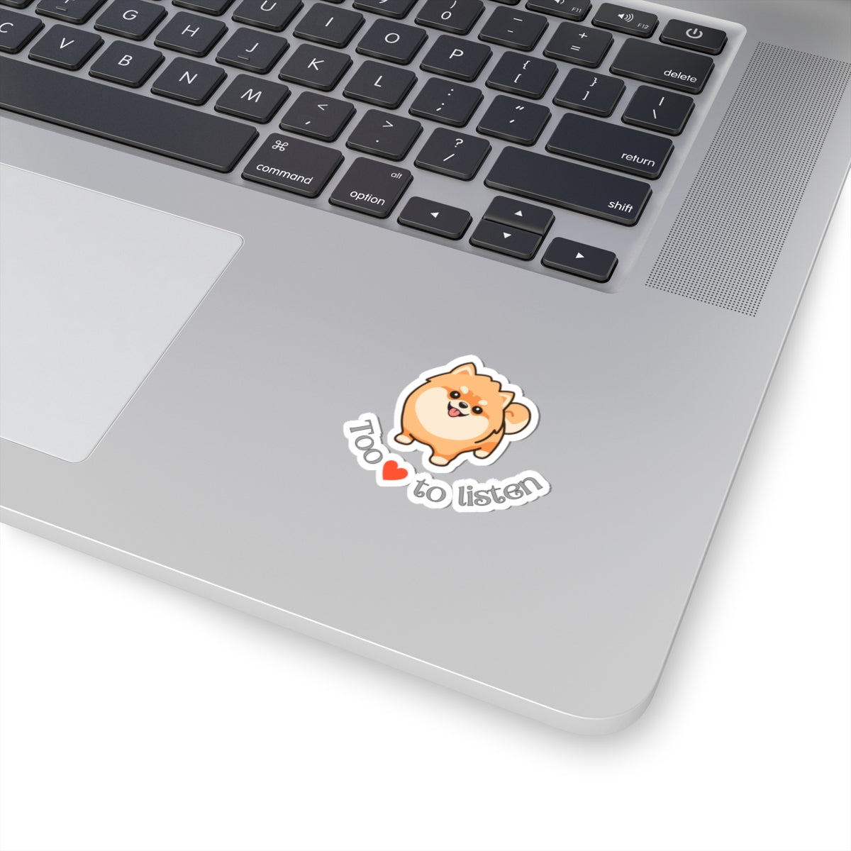 Kiss-cut sticker with Pomeranian graphic and too cute to listen slogan applied to laptop surface