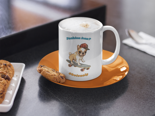 White coffee mug with French Bulldog graphic and fashion icon obviously slogan next to chocolate chip cookies