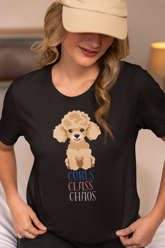 Woman wearing black Bella Canvas t shirt with poodle graphic and curls class chaos slogan at home while wearing a cap