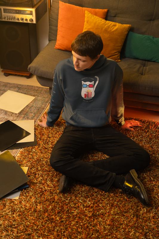 Man sitting on floor with music records wearing black Gildan hoodie with cat in 3D glasses holding popcorn and snacks ready movie time slogan