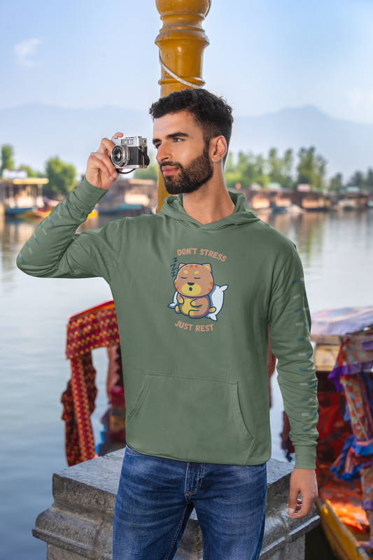 Bearded man taking photo with vintage camera wearing military green color  Gildan pullover hoodie with sleepy cat graphic and don’t stress just rest slogan